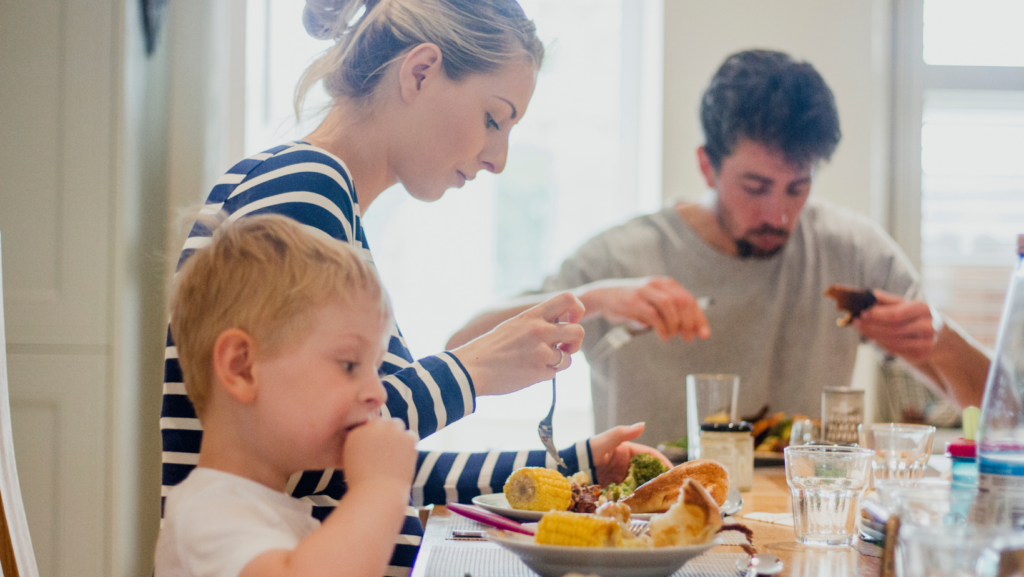 tips for frugal living - picture of family with a toddler eating dinner
